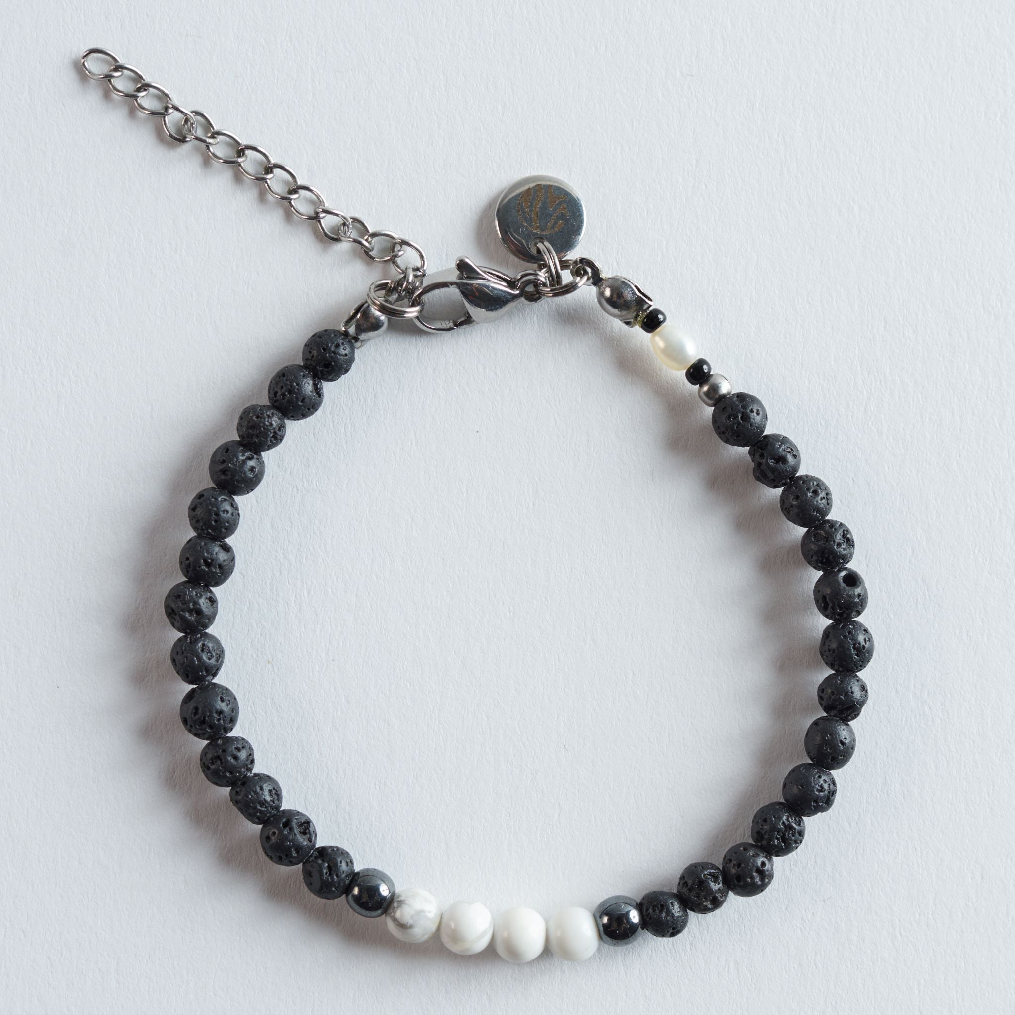 Das Armband Lava White IIII greift dieselbe ruhige Farbwelt wie Version I auf, setzt jedoch auf einen anderen Fokus im Steinverlauf. Die Kombination aus Lavastein, Hämatit und Howlith wirkt modern und leicht kontrastreicher.

Durch die feinen Weißnuancen entsteht ein ausgewogenes, sauberes Design, das sich besonders gut als dezentes Alltagsarmband eignet.